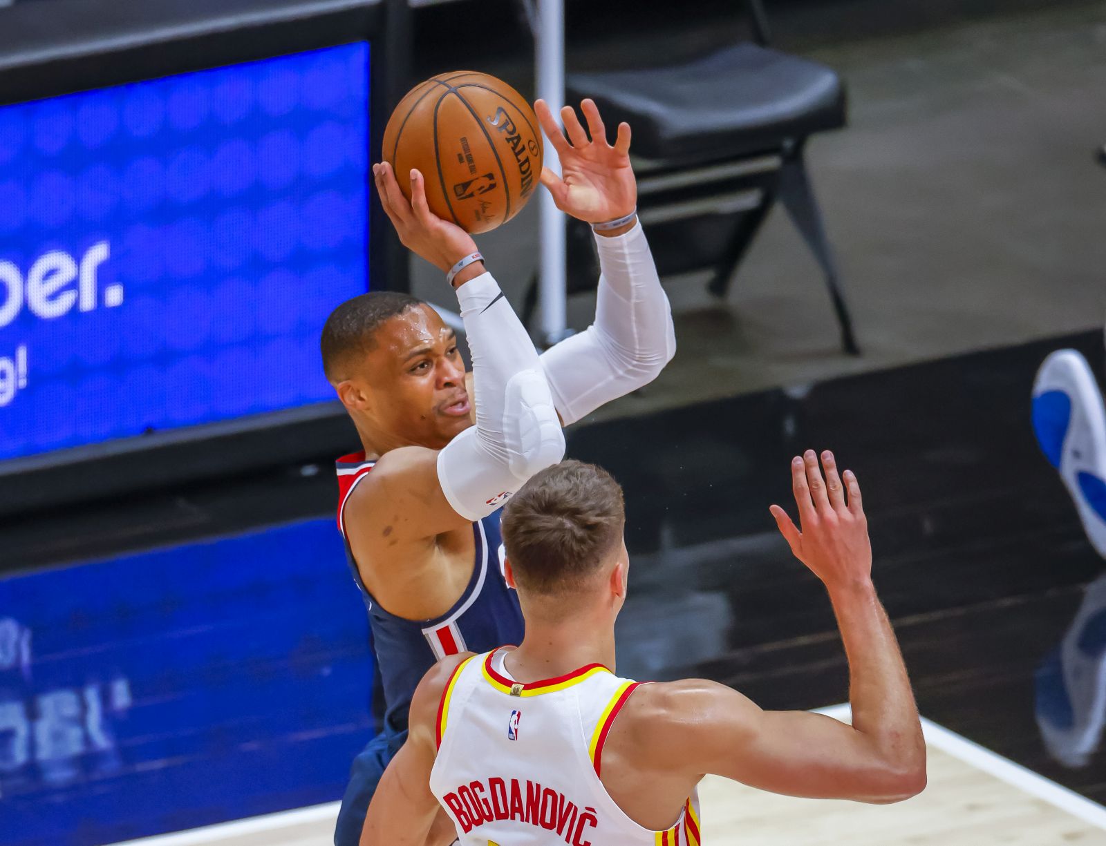 epa09190455 Washington Wizards guard Russell Westbrook (L) shoots as Atlanta Hawks guard Bogdan Bogdanovic (R) of Serbia guards during the first half of the NBA basketball game between the Washington Wizards and the Atlanta Hawks at State Farm Arena in Atlanta, Georgia, USA, 10 May 2021.  EPA/ERIK S. LESSER SHUTTERSTOCK OUT