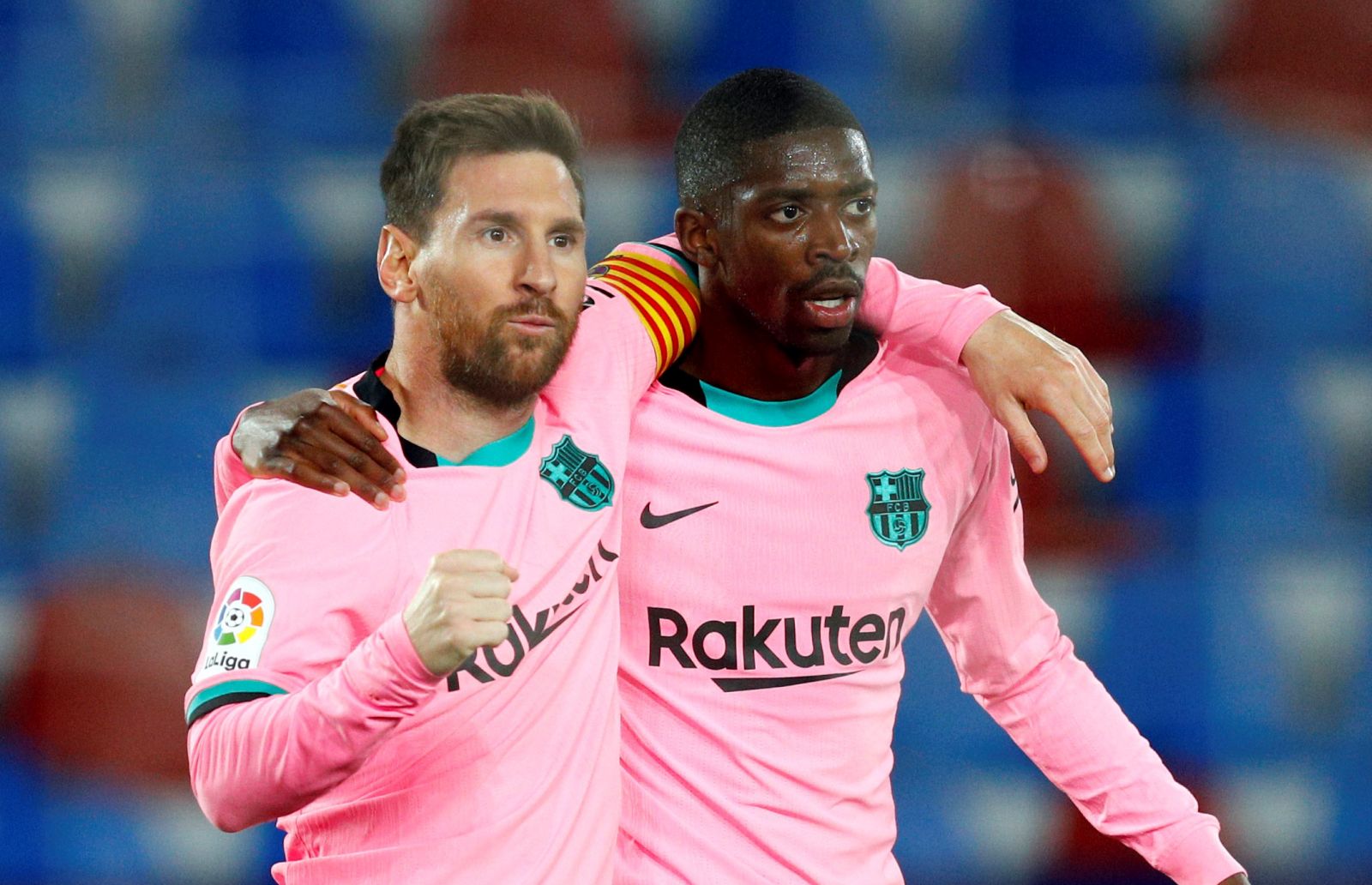 epa09192443 FC Barcelona's Lionel Messi (L) celebrates with teammate Ousmane Dembele after scoring the 0-1 during the Spanish LaLiga soccer match between Levante UD and FC Barcelona at Ciutat de Valencia stadium in Valencia, eastern Spain, 11 May 2021.  EPA/Juan Carlos Cardenas