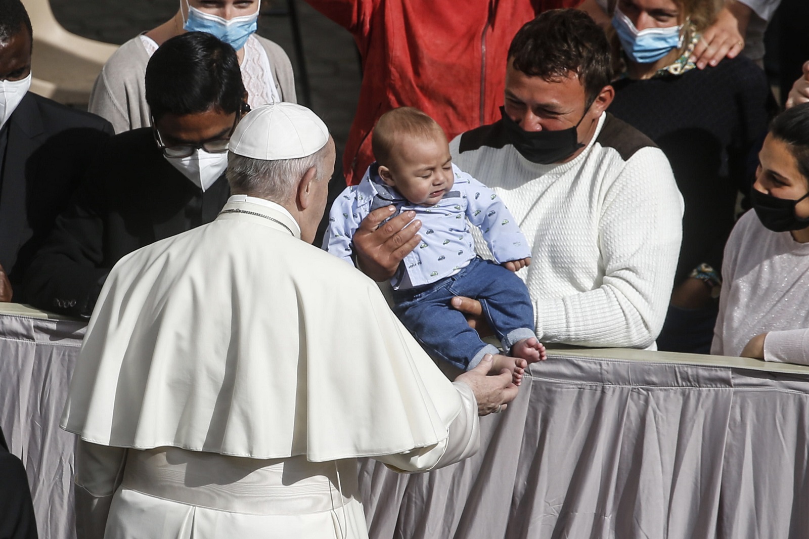 epa09193142 Pope Francis hugs a child during the general audience with the public after the restrictions due to the coronavirus pandemic were lifted at the Vatican, 12 May 2021.  EPA/FABIO FRUSTACI