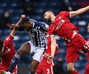 epa09204613 Semi Ajayi (C) of West Bromwich in action against Rhys Williams (L) and Nathaniel Phillips (R) of Liverpool during the English Premier League soccer match between West Bromwich Albion and Liverpool FC in West Bromwich, Britain, 16 May 2021.  EPA/Laurence Griffiths / POOL EDITORIAL USE ONLY. No use with unauthorized audio, video, data, fixture lists, club/league logos or 'live' services. Online in-match use limited to 120 images, no video emulation. No use in betting, games or single club/league/player publications.