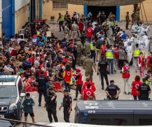 epa09213424 Dozens of underage migrants wait for a COVID-19 test after their arrival in Ceuta, Spain, 19 May 2021. Spain's Government considers that the massive arrival of some 8,000 irregular migrants to Ceuta from Morocco since 18 May is an assault on the border caused by the lack of control of the border by Morocco's Government and not a migratory crisis.  EPA/BRAIS LORENZO