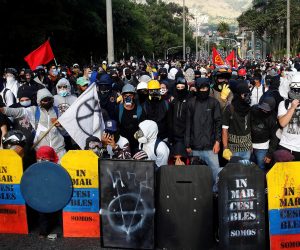 epa09214079 A group of so-called front-line protesters carry their handmade shields during a new day of the National Strike against the Government in Medellin, Colombia, 19 May 20. The streets of the main cities of Colombia were filled again after 22 days of mobilizations in which social pressure overthrew the tax reform of the Government of President Ivan Duque, which triggered the massive marches since 28 April.  EPA/Luis Eduardo Noriega