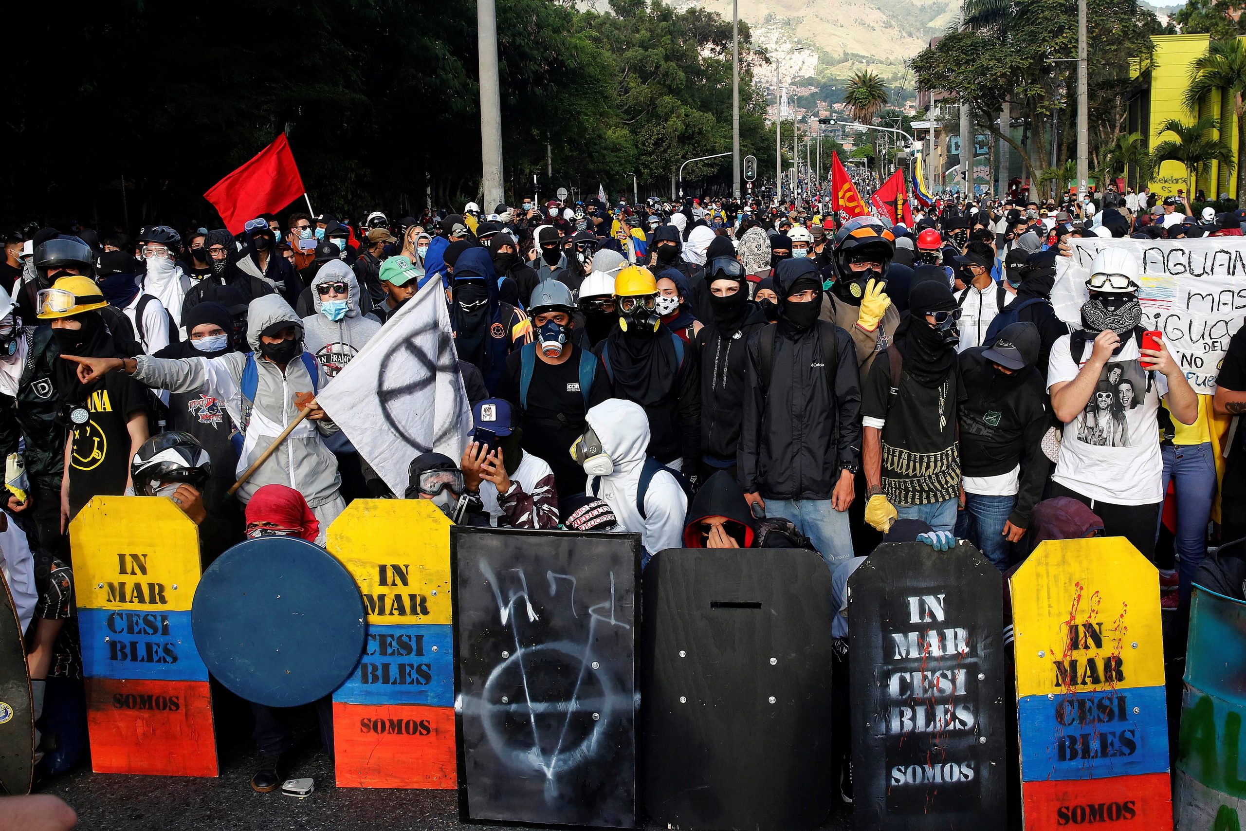 epa09214079 A group of so-called front-line protesters carry their handmade shields during a new day of the National Strike against the Government in Medellin, Colombia, 19 May 20. The streets of the main cities of Colombia were filled again after 22 days of mobilizations in which social pressure overthrew the tax reform of the Government of President Ivan Duque, which triggered the massive marches since 28 April.  EPA/Luis Eduardo Noriega