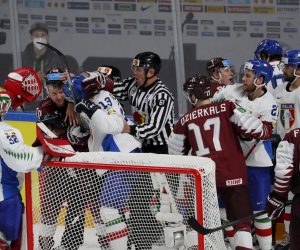 epa09225294 Players of Latvia (red) and players of Italy (white) in action during the IIHF 2021 World Ice Hockey Championships group B match between Latvia and Italy at the Arena Riga, Latvia, 24 May 2021.  EPA/TOMS KALNINS