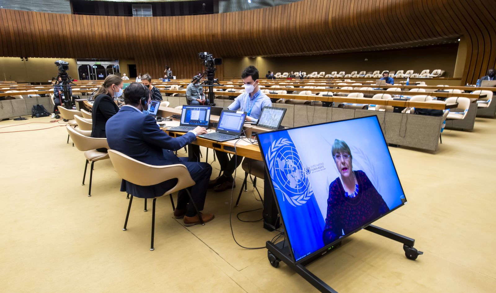 epa09230826 UN High Commissioner for Human Rights Michelle Bachelet, is seen on a screen delivering her speech during a special session of the UN Human Rights Council to discuss situation in the Occupied Palestinian Territory, at the European headquarters of the United Nations in Geneva, Switzerland, 27 May 2021.  EPA/MARTIAL TREZZINI
