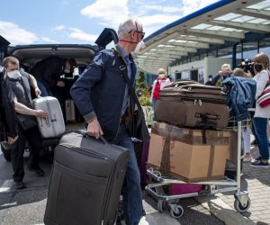 epa09234727 People arrive with luggage at the airport after a Russian special government plane landed at the Vaclav Havel Airport in Prague, Czech Republic, 29 May 2021. Tensions in Czech-Russian relations resulted from the findings of the Czech intelligence services asserting that members of the Russian secret service GRU were involved in the explosion of an ammunition complex in Vrbetice in 2014. The Czech Republic expelled 18 diplomats who were identified as members of the Russian secret services GRU and SVR from the Russian Embassy in Prague in April 2021. In retaliation, Russia then identified as undesirable 20 employees of the Czech Embassy in Moscow. Later, after diplomatic negotiations failed, the Czech side decided to reduce the number of Russian Embassy workers in Prague to cap the current number of staff at the Czech Embassy in Moscow by the end of May 2021.  EPA/MARTIN DIVISEK