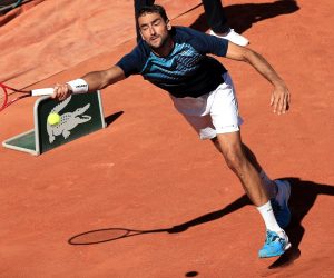 epa09239370 Marin Cilic of Croatia in action against Arthur Rinderknech of France during their first round match at the French Open tennis tournament at Roland Garros in Paris, France, 31 May 2021.  EPA/CHRISTOPHE PETIT TESSON