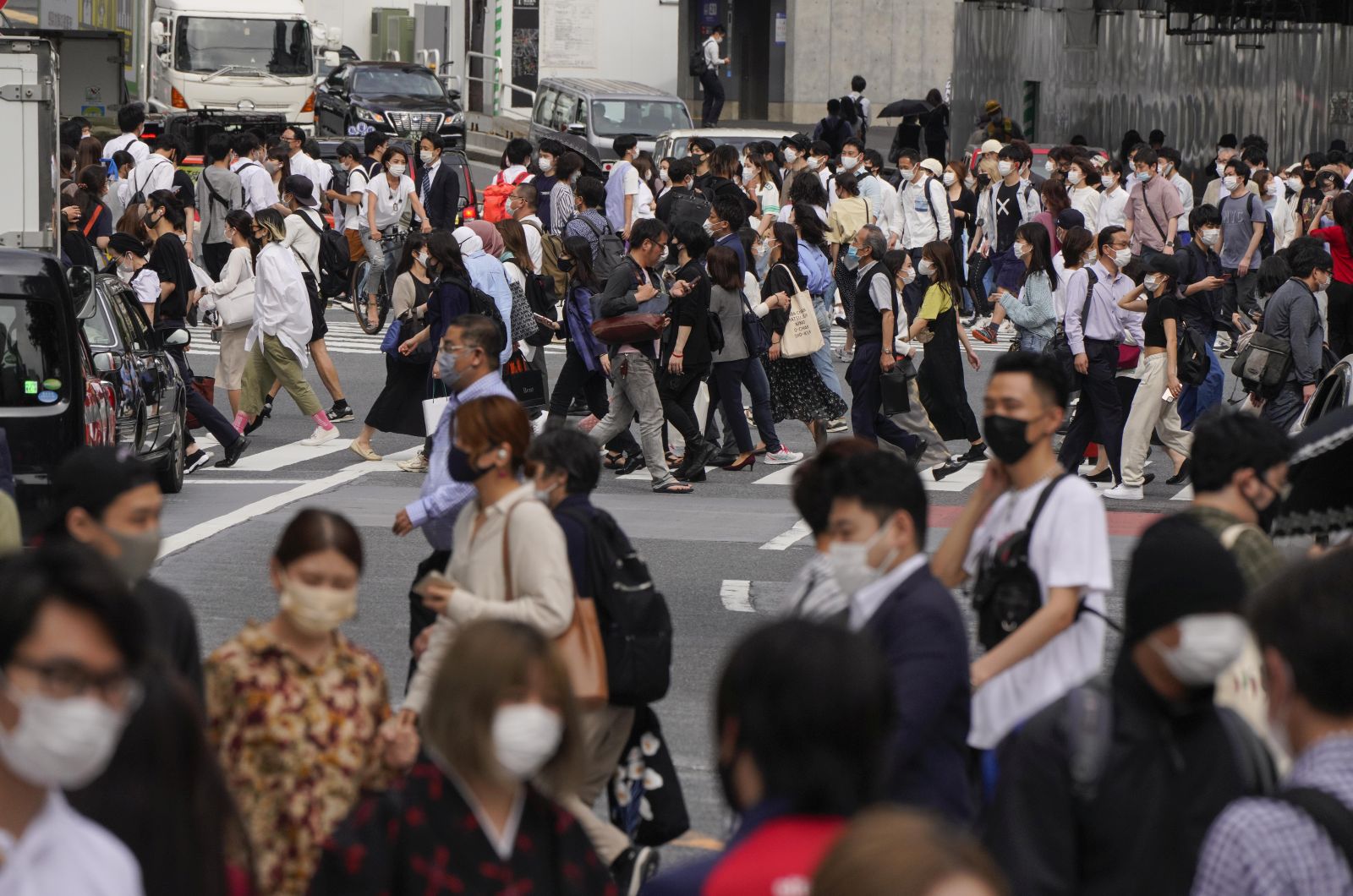 epa09232787 Pedestrians walk along the Shibuya scramble crossway in Tokyo, Japan, 28 May 2021. Japanese Prime Minister Yoshihide Suga decided to extend a state of emergency for the COVID-19 coronavirus pandemic in nine prefectures including Tokyo until 20 June 2021, originally scheduled until 31 May. Suga will announce the decision at a televised news conference later on 28 May 2021. Some opinion polls by Japanese media show more than 80 percent of people support the cancellation or postponement of the Tokyo 2020 Olympic Games while Japanese people who have been vaccinated at least once is about six percent. It is said Japan's vaccination rate is very low, the lowest among OECD member countries.  EPA/KIMIMASA MAYAMA