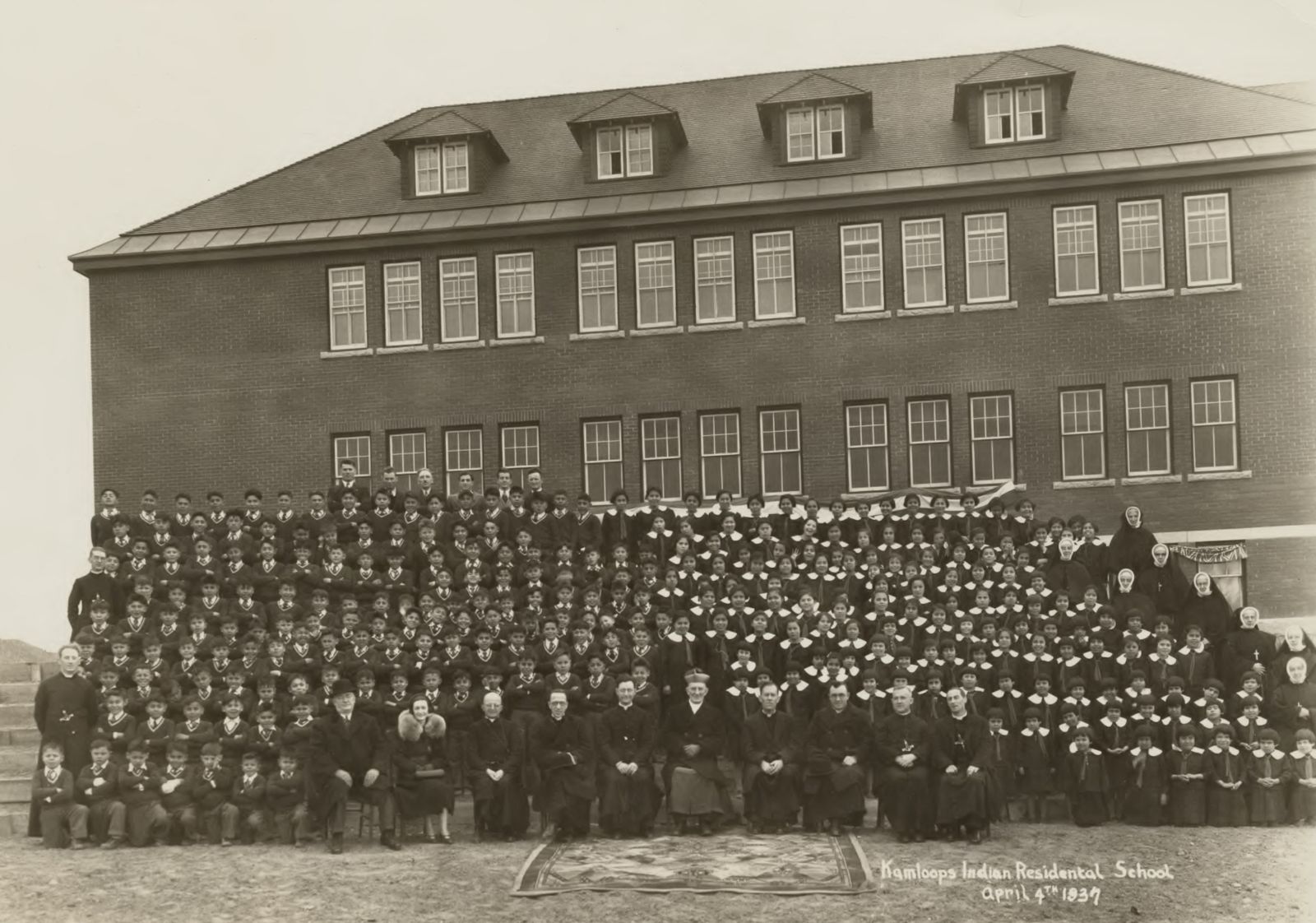 epa09236275 A handout photo made available by the National Centre for Truth and Reconciliation at the University of Manitoba reportedly shows a gathering at the Kamloops Indian Residential School in Kamloops, British Columbia, Canada in 1937 (issued on 29 May 2021). According to a statement issued by Chief Rosanne Casimir of the Tk'emlups te Secwépemc First Nation on 27 May 2021 a mass grave has been located at the site of the school that contains the bodies of 215 children whose deaths went undocumented. The school operated from 1890 through 1978 as a place to force youth from indigenous tribes into giving up their language and culture.  EPA/NATIONAL CENTER FOR TRUTH AND RECONCILIATION / HANDOUT BEST QUALITY AVAILABLE HANDOUT EDITORIAL USE ONLY/NO SALES