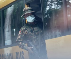 epaselect epa09240353 Soldiers board a school bus outside a high school in Yangon, Myanmar, 01 June 2021. Schools in Myanmar open for the new school year even after the military suspended thousands of teachers for joining a civil disobedience movement protesting the 01 February military coup.  EPA/STRINGER