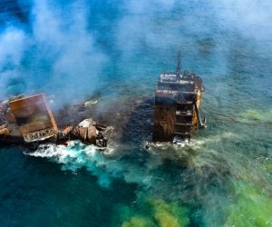 epa09243157 A handout photo made available by the Sri Lankan Air force Media shows the fire gutted and crippled Singapore-registered container cargo vessel, MV X-Press Pearl, on the 9 nautical miles northwest of Colombo port in Colombo, Sri Lanka, 02 June 2021. The fire on the Singaporean flagged container cargo vessel MV X-Press Pearl, which had been burning for over 13 days, was doused and the salvage company began towing it towards deeper seas off the coast of Colombo on 02 June. However, latest reports by the Sri Lanka Navy stated that the towing operation had been halted as the stern of the ship was striking the seabed. They also reported that so far no oil spills have been observed. A huge amount of plastic granules and debris has already washed ashore on beaches from Colombo to Negombo and authorities now fear another wave of massive pollution should the 278 tonnes of bunker oil and 50 tonnes of gas in the Singapore-registered ship's fuel tanks leak into the Indian Ocean.  EPA/SRI LANKAN AIR FORCE MEDIA HANDOUT  HANDOUT EDITORIAL USE ONLY/NO SALES
