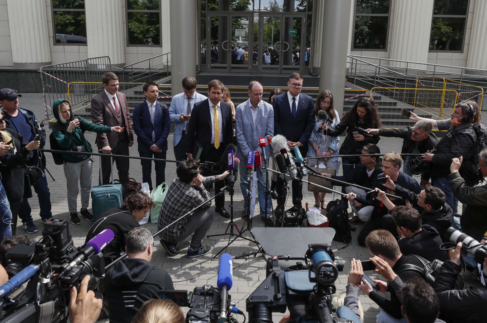 epa09257271 Ivan Pavlov (C), an opposition-minded lawyer and his legal group representing the Anti-Corruption Foundation (FBK), speak to media in front of the Moscow City Court in Moscow, Russia, 09 June 2021. The court continues the hearing, behind the closed doors, on a lawsuit filed by the Moscow Prosecutor's Office to recognize Anti-Corruption Foundation (FBK) and the headquarters of jailed opposition leader Alexei Navalny as extremist organizations. The court suspended the organizations' activities until the decision on the extremism lawsuit.  EPA/YURI KOCHETKOV