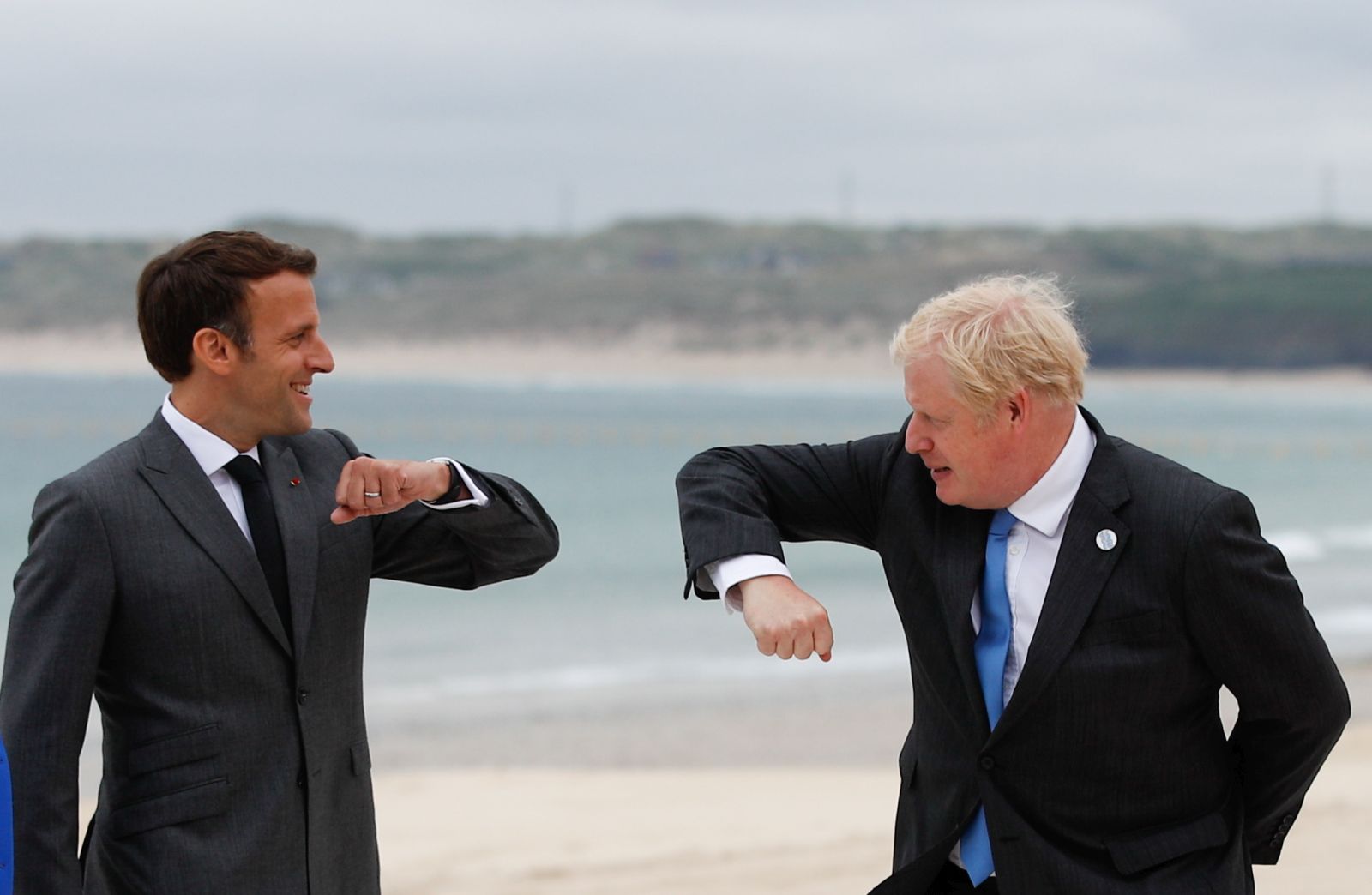 epa09262128 Britain's Prime Minister Boris Johnson (R) greets France's President Emmanuel Macron (L) as they arrive for the G7 summit in Carbis Bay, Cornwall, Britain, 11 June 2021.  EPA/PHIL NOBLE / POOL