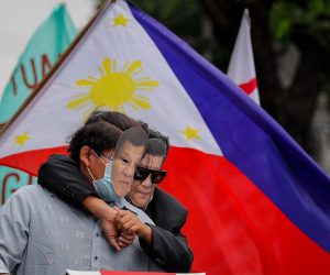 epa09263839 Demonstrators dressed as Chinese President Xi Jinping (R) and Philippines President Rodrigo Duterte (L) pose for pictures during a protest to mark the 123rd Independence Day at the Chinese Consulate in Makati, Metro Manila, Philippines, 12 June 2021. Various militant groups held a demonstration at the Chinese Consulate to denounce China's continued presence and activities inside Philippine territory in the disputed South China sea.  EPA/MARK R. CRISTINO