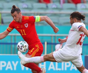 epa09264326 Gareth Bale (L) of Wales in action against Ricardo Rodriguez (R) of Switzerland during the UEFA EURO 2020 group A preliminary round soccer match between Wales and Switzerland in Baku, Azerbaijan, 12 June 2021.  EPA/Tolga Bozoglu / POOL (RESTRICTIONS: For editorial news reporting purposes only. Images must appear as still images and must not emulate match action video footage. Photographs published in online publications shall have an interval of at least 20 seconds between the posting.)
