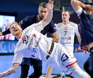 epa09264490 Aalborg's Rene Antonsen (front) in action against Paris' Luka Karabatic (rear) during the 2021 EHF FINAL4 Handball Champions League semi final match between Paris Saint-Germain and Aalborg Haandbold in Cologne, Germany, 12 June 2021.  EPA/SASCHA STEINBACH