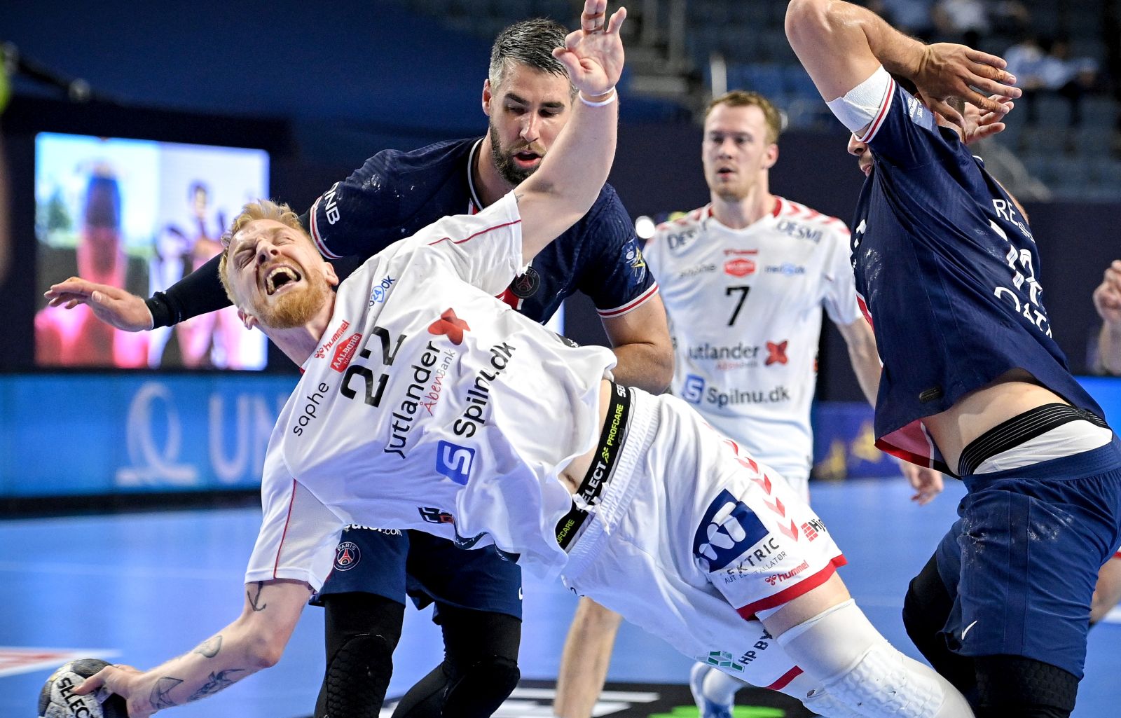 epa09264490 Aalborg's Rene Antonsen (front) in action against Paris' Luka Karabatic (rear) during the 2021 EHF FINAL4 Handball Champions League semi final match between Paris Saint-Germain and Aalborg Haandbold in Cologne, Germany, 12 June 2021.  EPA/SASCHA STEINBACH