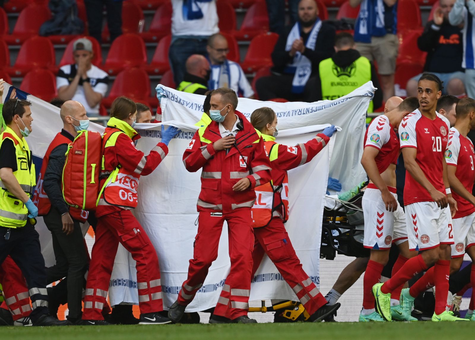 epa09265391 Christian Eriksen (hidden) of Denmark is carried from the pitch during the UEFA EURO 2020 group B preliminary round soccer match between Denmark and Finland in Copenhagen, Denmark, 12 June 2021.  EPA/Stuart Franklin / POOL (RESTRICTIONS: For editorial news reporting purposes only. Images must appear as still images and must not emulate match action video footage. Photographs published in online publications shall have an interval of at least 20 seconds between the posting.)