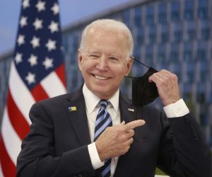epa09269754 US President Joe Biden takes off his face mask he meets with NATO Secretary General Jens Stoltenberg (not pictured) during a NATO summit at the North Atlantic Treaty Organization (NATO) headquarters in Brussels, Belgium, 14 June 2021. The 30-nation alliance hopes to reaffirm its unity and discuss increasingly tense relations with China and Russia, as the organization pulls its troops out after 18 years in Afghanistan.  EPA/STEPHANIE LECOCQ / POOL