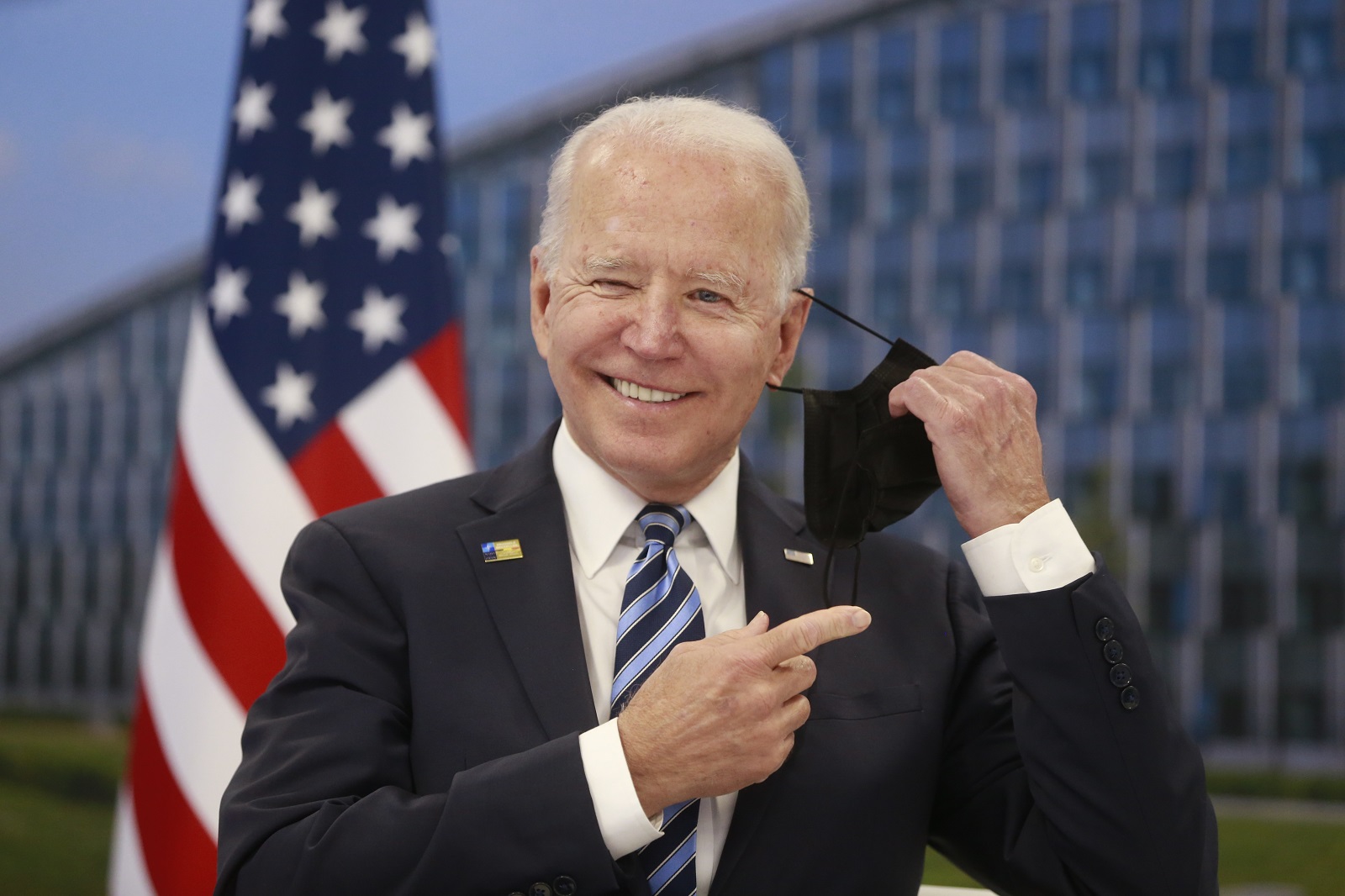 epa09269754 US President Joe Biden takes off his face mask he meets with NATO Secretary General Jens Stoltenberg (not pictured) during a NATO summit at the North Atlantic Treaty Organization (NATO) headquarters in Brussels, Belgium, 14 June 2021. The 30-nation alliance hopes to reaffirm its unity and discuss increasingly tense relations with China and Russia, as the organization pulls its troops out after 18 years in Afghanistan.  EPA/STEPHANIE LECOCQ / POOL