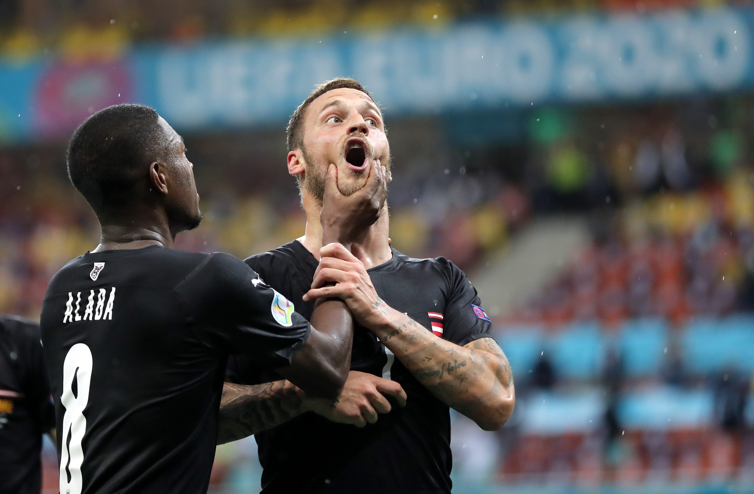 epa09276312 (FILE) - Marko Arnautovic (R) of Austria celebrates with team-mate David Alaba after scoring the third goal of his team during the UEFA EURO 2020 group C preliminary round soccer match between Austria and North Macedonia in Bucharest, Romania, 13 June 2021 (reissued 16 June 2021. The UEFA Appeals Body has announced on 16 June 2021 to suspend Arnautovic for the next game for insulting another player.  EPA/Robert Ghement / POOL (RESTRICTIONS: For editorial news reporting purposes only. Images must appear as still images and must not emulate match action video footage. Photographs published in online publications shall have an interval of at least 20 seconds between the posting.)