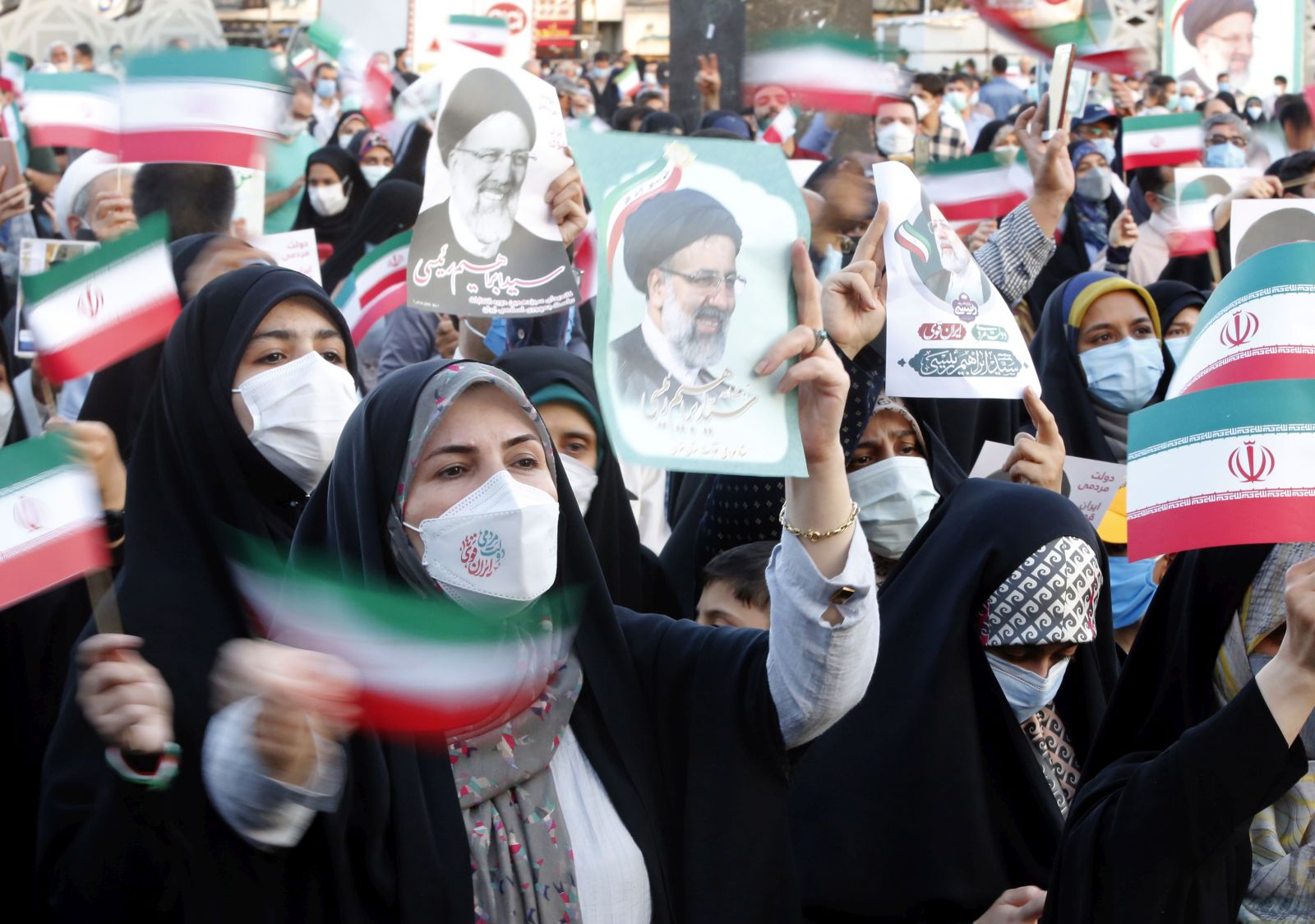 epa09286221 Supporters of Iranian president elect Ebrahim Raisi celebrate in Imam Hussein square in Tehran, Iran, 19 June 2021. According to an interior ministry official, Raisi with 17.9 million votes won the presidential election. More than 28 million Iranians out of 59 million eligible voters had cast their ballots in the Iranian Presidential election.  EPA/ABEDIN TAHERKENAREH