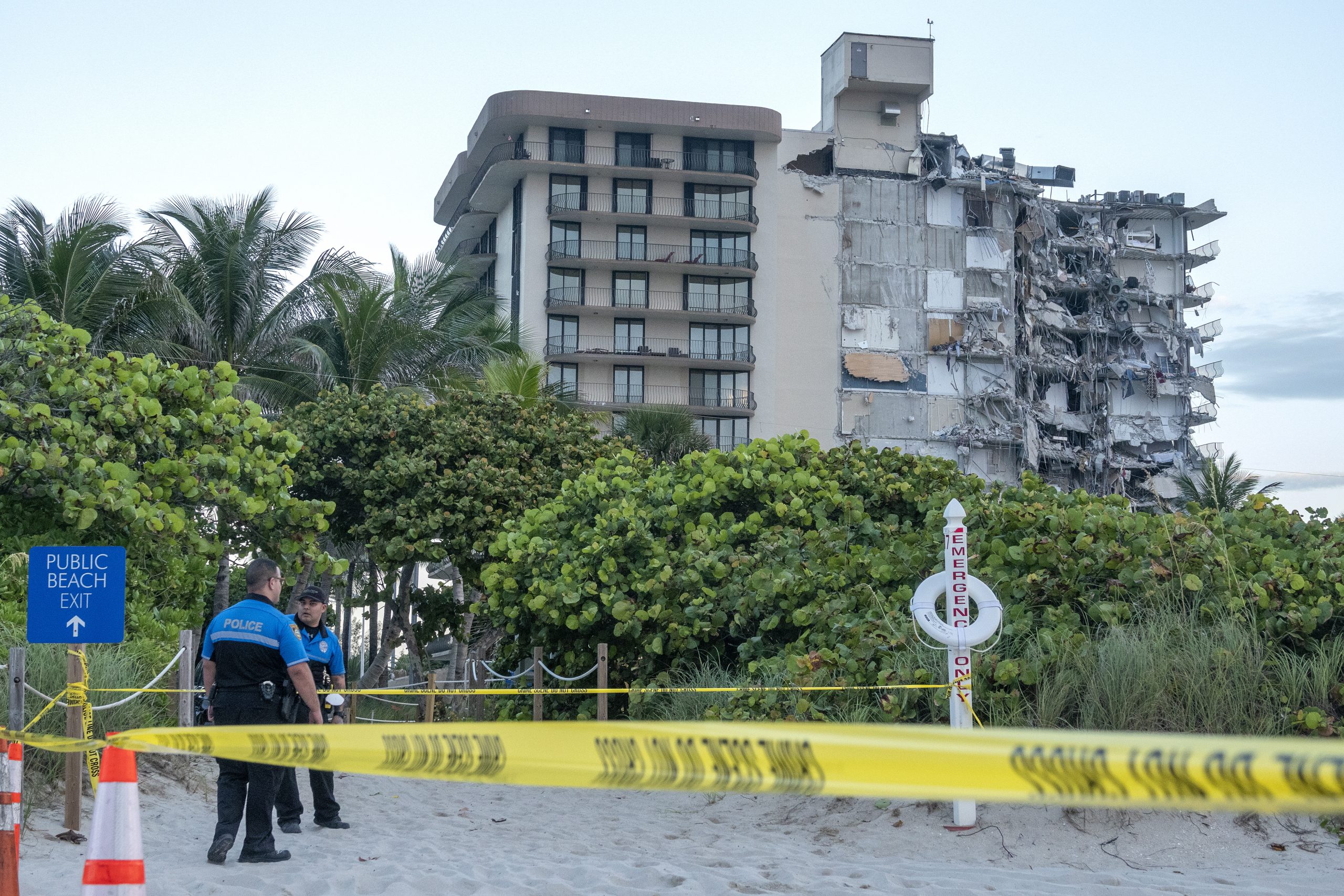 epa09298424 Miami Dade police officers guard the entrance to the partial collapsed 12-story condominium building in Surfside, Florida, USA, 24 June 2021. Miami-Dade Fire Rescue officials said more than 80 units responded to the collapse at the condominium building near 88th Street and Collins Avenue just north of Miami Beach around 2 a.m.  EPA/CRISTOBAL HERRERA-ULASHKEVICH