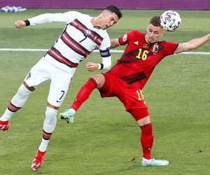 epa09306299 Thorgan Hazard (R) of Belgium in action against Cristiano Ronaldo (L) of Portugal during the UEFA EURO 2020 round of 16 soccer match between Belgium and Portugal in Seville, Spain, 27 June 2021.  EPA/Jose Manuel Vidal / POOL (RESTRICTIONS: For editorial news reporting purposes only. Images must appear as still images and must not emulate match action video footage. Photographs published in online publications shall have an interval of at least 20 seconds between the posting.)