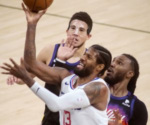 epa09310016 Los Angeles Clippers guaurd Marcus Morris Sr. (C) puts up a shot against Phoenix Suns defenders, Jai Crowder (R) and Devin Booker (L) in the second half of game five of the 2021 NBA Western Conference Finals basketball playoff series between the Phoenix Suns and the Los Angeles Clippers at Talking Stick Arena in Phoenix, Arizona, USA, 28, June 2021.  EPA/Rick D'Elia  SHUTTERSTOCK OUT