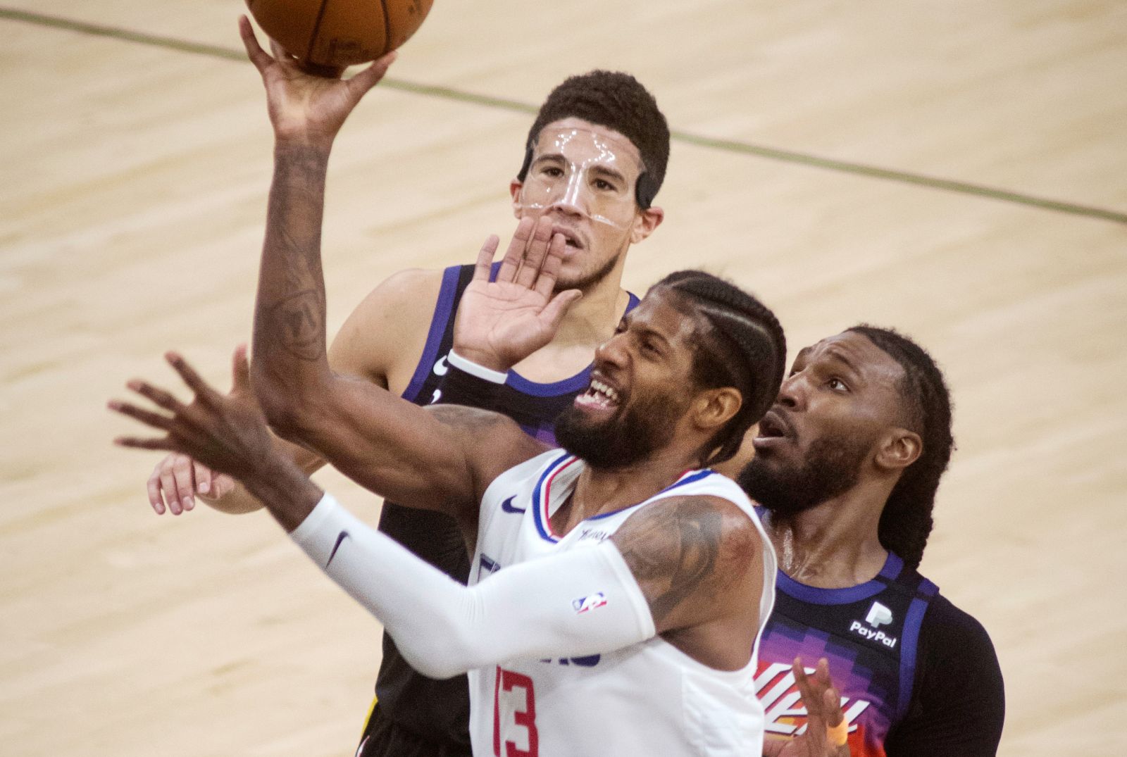 epa09310016 Los Angeles Clippers guaurd Marcus Morris Sr. (C) puts up a shot against Phoenix Suns defenders, Jai Crowder (R) and Devin Booker (L) in the second half of game five of the 2021 NBA Western Conference Finals basketball playoff series between the Phoenix Suns and the Los Angeles Clippers at Talking Stick Arena in Phoenix, Arizona, USA, 28, June 2021.  EPA/Rick D'Elia  SHUTTERSTOCK OUT