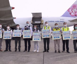 epa09287832 A handout photo made available by Taiwan Centers for Disease Control shows Taiwan Health Minister Chen Shih-chung(4R),  American Institute in Taiwan (AIT) Director Brent Christensen(5R) and Taiwanese officials posing for photograph next to airport workers unloading from a cargo plane boxes of Moderna Covid-19 vaccine from the US, in Taoyuan International airport, Taiwan, 20 June 2021. Taiwan received 2.5 million doses of Moderna Covid-19 vaccine donated by the United States government. Taiwan President Tsai Ing-wen thanked the US Government for the donation.  EPA/TAIWAN CDC HANDOUT  HANDOUT EDITORIAL USE ONLY/NO SALES HANDOUT EDITORIAL USE ONLY/NO SALES