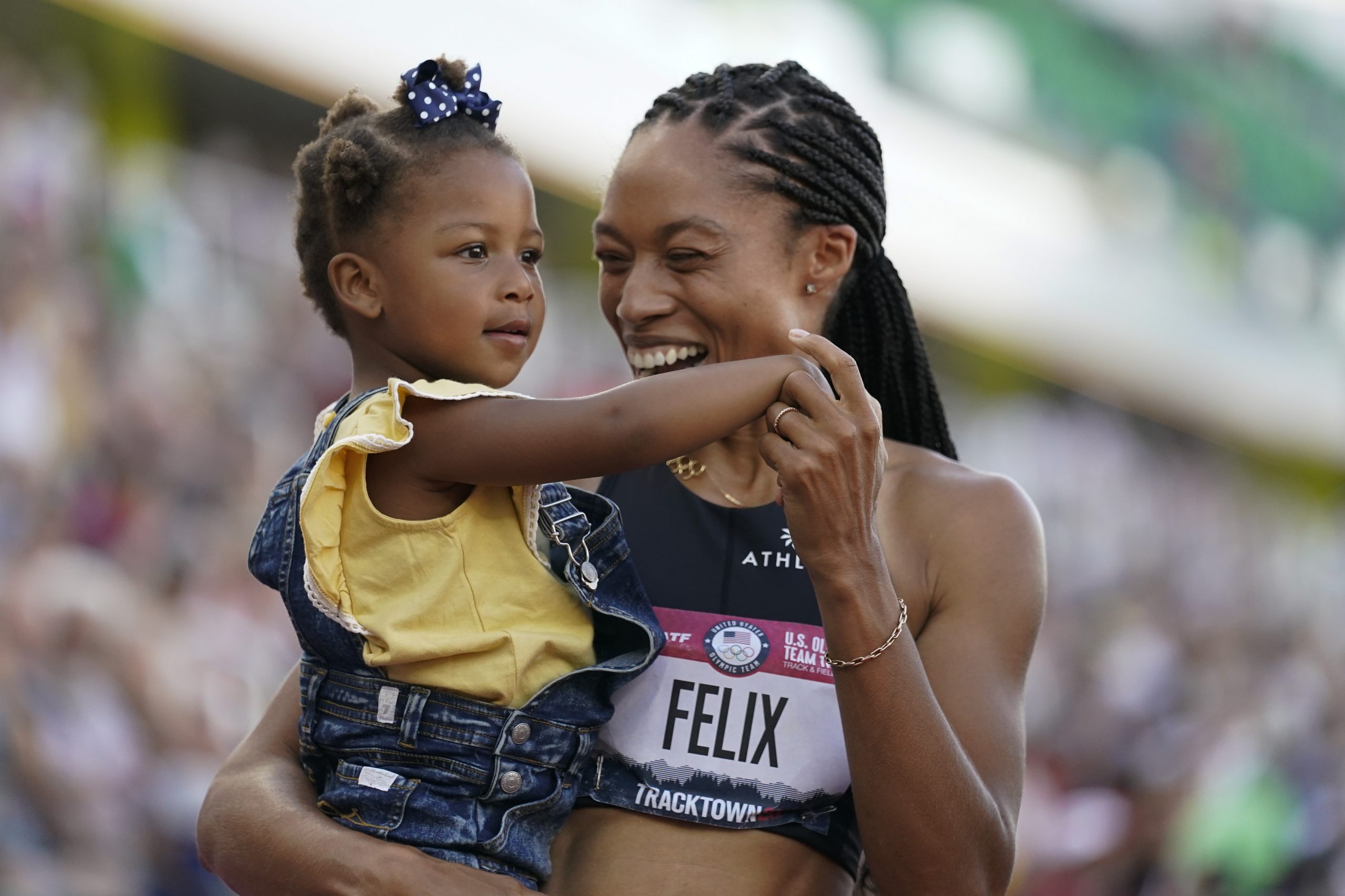 Allyson Felix celebrates after her second place finish in the women's 400-meter run with her daughter Camryn at the U.S. Olympic Track and Field Trials Sunday, June 20, 2021, in Eugene, Ore.(AP Photo/Ashley Landis)