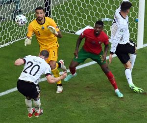 epa09286473 Robin Gosens (L) of Germany scores the 1-4 goal during the UEFA EURO 2020 group F preliminary round soccer match between Portugal and Germany in Munich, Germany, 19 June 2021.  EPA/Matthias Hangst / POOL (RESTRICTIONS: For editorial news reporting purposes only. Images must appear as still images and must not emulate match action video footage. Photographs published in online publications shall have an interval of at least 20 seconds between the posting.)