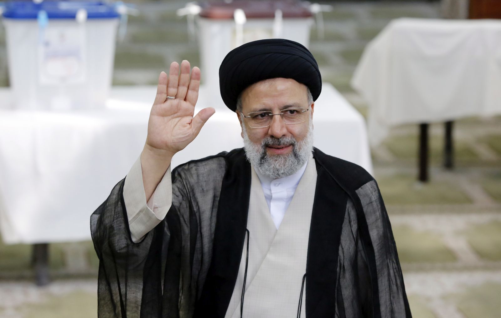 epa09284834 (FILE) - Iranian presidential candidate Ebrahim Raisi greets media  after casting his vote during the presidential elections in a mosque in Shahre Ray, southern of Tehran, Iran, 18 June 2021 (Reissued 19 June 2021). According to an interior ministry official, Raisi won 17.8 million votes, so far. More than 28 million Iranians out of 59 million eligible voters had cast thier ballots in the Iranian Presidential election.  EPA/ABEDIN TAHERKENAREH