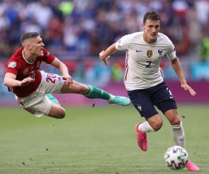 epa09285642 Roland Sallai (L) of Hungary in action against Benjamin Pavard of France during the UEFA EURO 2020 group F preliminary round soccer match between Hungary and France in Budapest, Hungary, 19 June 2021.  EPA/Alex Pantling / POOL (RESTRICTIONS: For editorial news reporting purposes only. Images must appear as still images and must not emulate match action video footage. Photographs published in online publications shall have an interval of at least 20 seconds between the posting.)