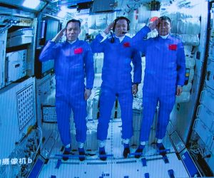 epa09281811 A screen image made available by Xinhua News Agency captured at the Beijing Aerospace Control Center shows three Chinese astronauts onboard the Shenzhou-12 spaceship saluting after entering the Tianhe space station core module in Beijing, China, 17 June 2021 (issued 18 June 2021). China launched the Shenzhou-12 spacecraft carrying three crew members Tang Hongbo, Nie Haisheng, and Liu Boming to the orbiting Tianhe core module for a three-month mission on 17 June. The mission is China's first manned spaceflight in almost five years.  EPA/XINHUA/JIN LIWANG MANDATORY CREDIT EDITORIAL USE ONLY/NO SALES
