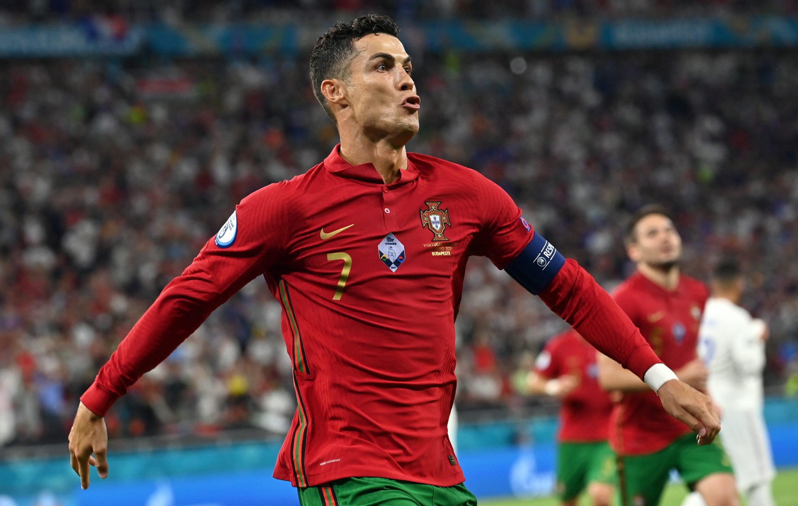 epa09296891 Cristiano Ronaldo of Portugal celebrates after scoring the 1-0 by penalty during the UEFA EURO 2020 group F preliminary round soccer match between Portugal and France in Budapest, Hungary, 23 June 2021.  EPA/Tibor Illyes / POOL (RESTRICTIONS: For editorial news reporting purposes only. Images must appear as still images and must not emulate match action video footage. Photographs published in online publications shall have an interval of at least 20 seconds between the posting.)
