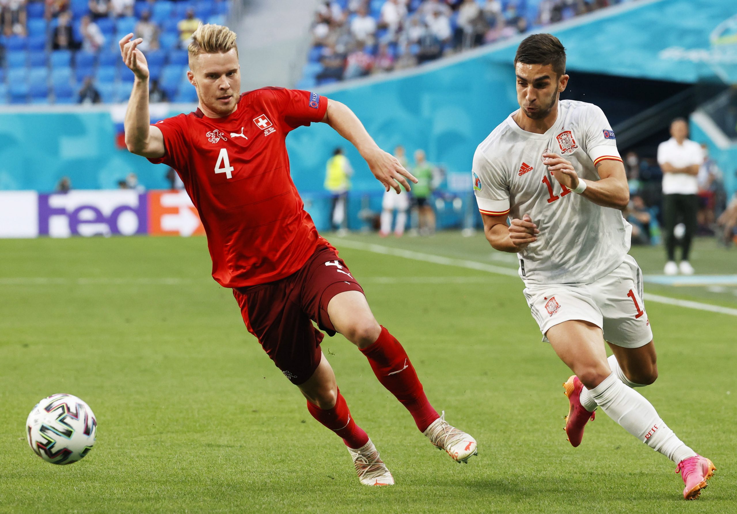 epa09318303 Ferran Torres of Spain in action against Nico Elvedi (L) of Switzerland during the UEFA EURO 2020 quarter final match between Switzerland and Spain in St.Petersburg, Russia, 02 July 2021.  EPA/Anatoly Maltsev / POOL (RESTRICTIONS: For editorial news reporting purposes only. Images must appear as still images and must not emulate match action video footage. Photographs published in online publications shall have an interval of at least 20 seconds between the posting.)