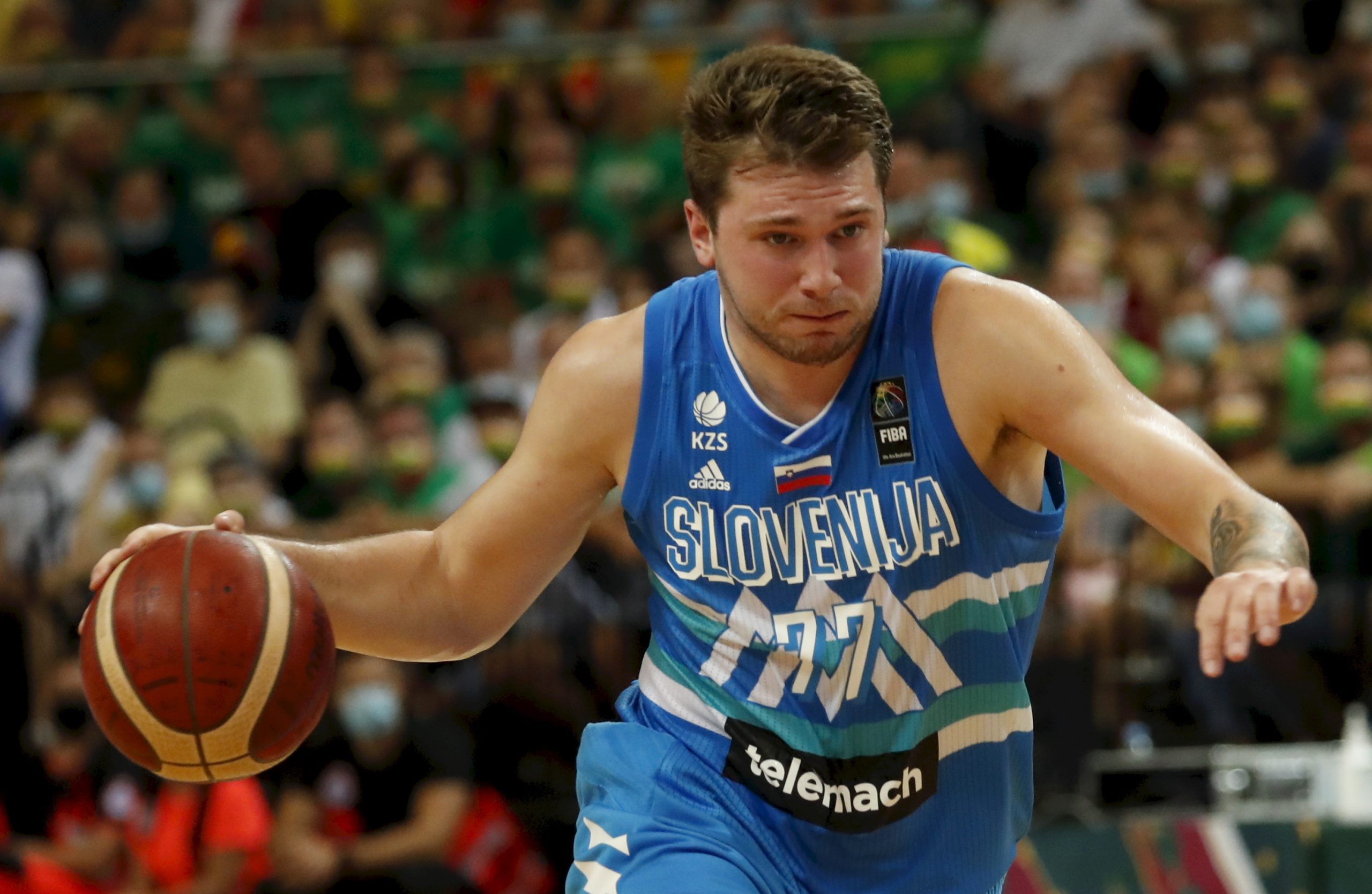 epa09322548 Luka Doncic of Slovenia in action during the FIBA Olympic Qualifying Tournament Men's Basketball final match beween Lithuania and Slovenia in Kaunas, Lithuania, 04 July 2021.  EPA/Toms Kalnins