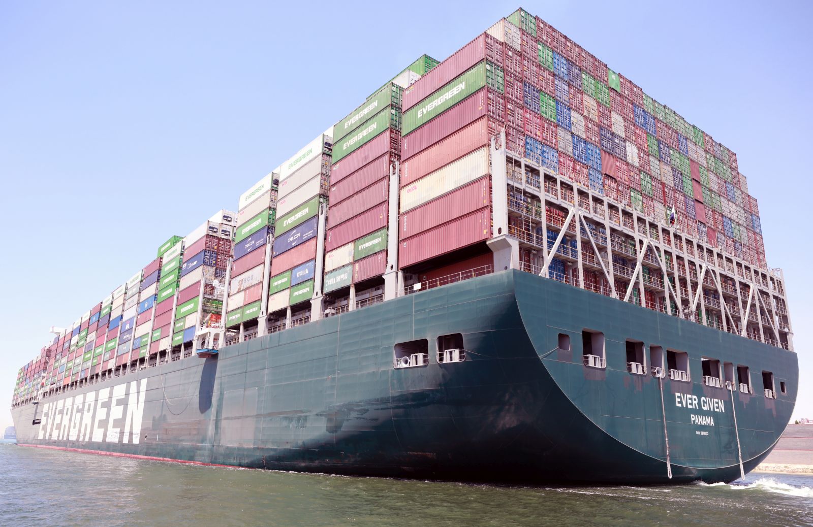 epa09328294 The container ship 'Ever Given' moves in the Suez Canal, Egypt, 07 July 2021. The Ever Given ran aground in the Suez Canal on 23 March, causing a huge traffic backlog of ships. The container ship that blocked the Suez Canal for almost a week has been detained with its crew in a lake between two stretches of the waterway since it was dislodged on 29 March. The Suez Canal Authority has previously announced that the ship will be allowed to sail on 07 July after a multimillion-dollar compensation deal was reached with the owner.  EPA/KHALED ELFIQI