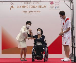 epa09332732 Aki Taguchi (C), official Ambassador of the Tokyo 2020 Torch Relay and Paralympian, hands over the Olympic Flame on a lantern to Tokyo Governor Yuriko Koike (L) during the unveiling ceremony for the Olympic Flame of the Tokyo 2020 Olympic Torch Relay at the Komazawa Olympic Park General Sports Ground in Tokyo, Japan, 09 July 2021. The Tokyo 2020 Olympic Torch Relay finally arrived in Tokyo on 09 July, two weeks before the opening of the Tokyo 2020 Olympic Games, which was delayed for one year due to the COVID-19 and Coronavirus pandemic. A five-party meeting decided on 08 July 2021 Tokyo venues for the Summer Games will be held without spectators.  EPA/KIMIMASA MAYAMA
