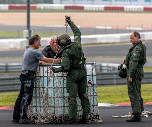 epa09351125 Bundeswehr staff prepares fresh drinking water to be airlifted with a helicopter to areas inaccessible following floodings, from the Nuerburgring race track where rescue forces are based in Nuerburg, Germany, 17 July 2021. Large parts of central Europe were hit by heavy and continuous rain resulting in local flash floods that destroyed buildings and swept away cars. At least 140 people died in Germany.  EPA/CONSTANTIN ZINN