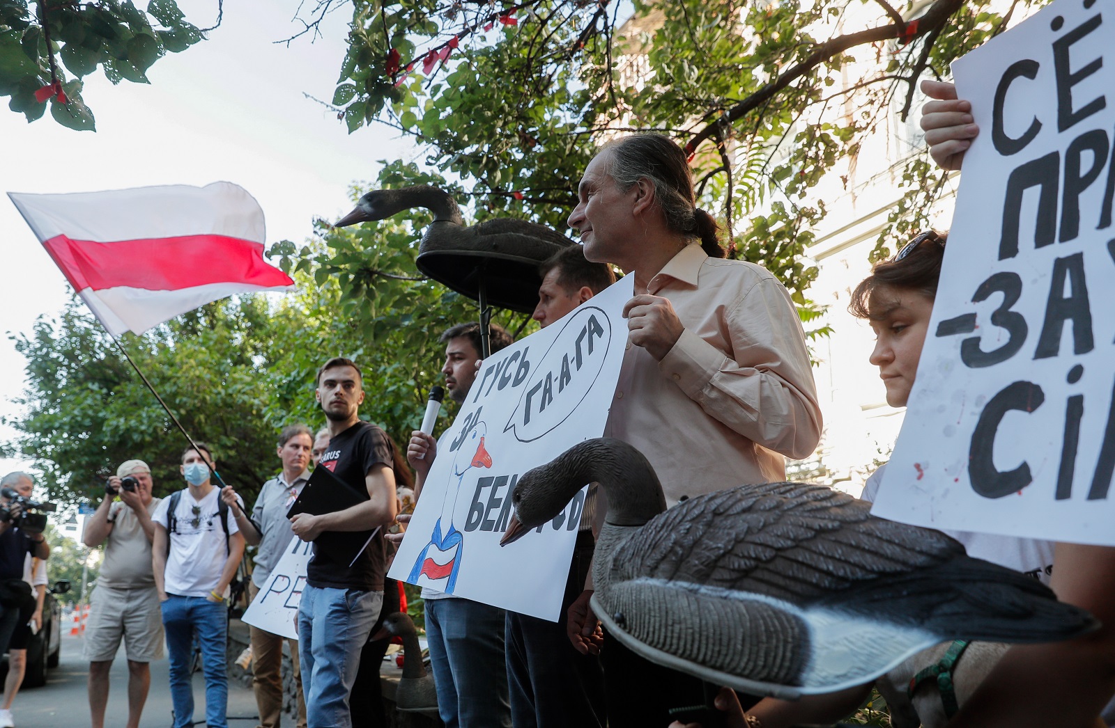 epa09359292 Belarusians living in Ukraine along with their supporters and Ukrainian activists hold placards and plastic gooses during a rally calling 'Goose for Belarus!', near the Belarus embassy in Kiev, Ukraine, 23 July 2021. According to protesters, they brought plastic gooses because the chatter of gooses resembles the name of the city of The Hague in Belarusian, Russian and Ukrainian languages (Ga-ga-ga - Gaaga) and as a reminder to Belarusian President Alexander Lukashenko about his liability for the persecution of the Belarusian opposition. A criminal complaint on behalf of four non-governmental organizations was filed On 19 May 2021 at the Pre-trial Chamber of the International Criminal Court (ICC) in The Hague.  EPA/SERGEY DOLZHENKO