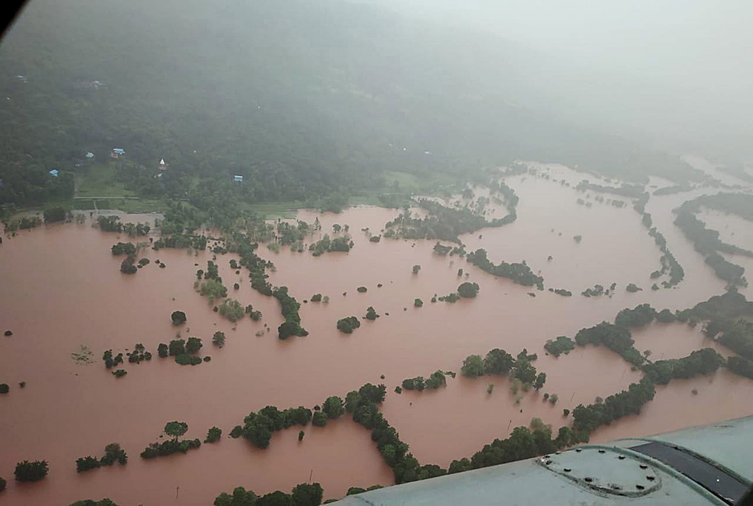 epa09359483 A handout photo made available by the Indian Navy while doing the helicopter sortie on 22 July 2021 shows an aerial view of the Ratnagiri district, Maharashtra, India, 22 July 2021 (issued 23 July 2021).  According to the district administration severe rainfall in Maharashtra killed at least 36 people and another 30 are feared trapped in three landslides in various areas.  EPA/INDIAN NAVY HANDOUT  HANDOUT EDITORIAL USE ONLY/NO SALES