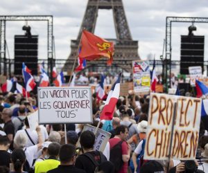 epa09362518 Thousands of protesters gather at Place Trocadero near the Eiffel Tower during a demonstration against the COVID-19 sanitary pass which grants vaccinated individuals greater ease of access to venues in France, in Paris, France, 24 July 2021. France has extended the use of its Vaccinal Passeport to cultural place, transport, restaurants, etc, after Covid-19 infections soared this week due to the more infectious Delta variant.  EPA/IAN LANGSDON
