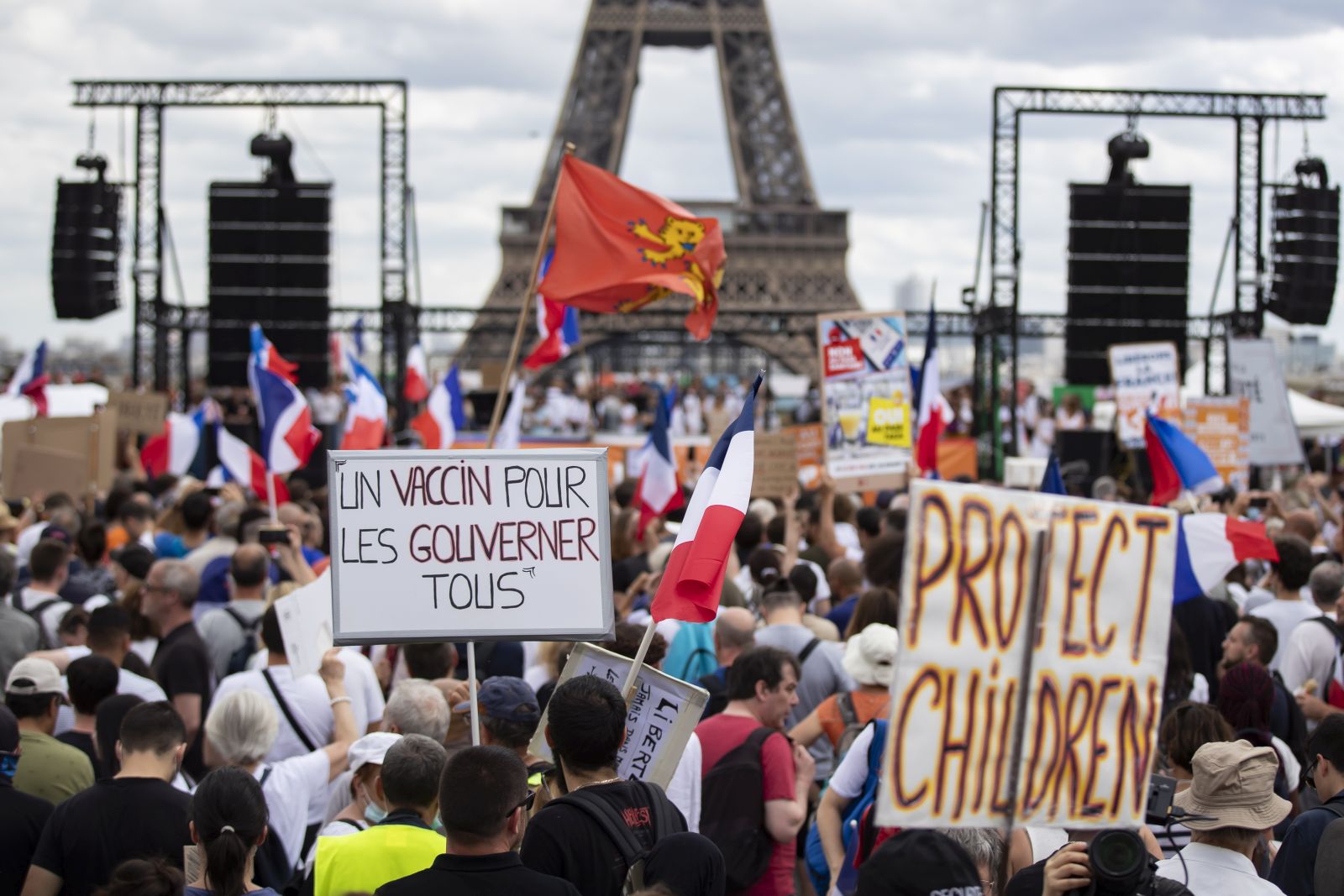 epa09362518 Thousands of protesters gather at Place Trocadero near the Eiffel Tower during a demonstration against the COVID-19 sanitary pass which grants vaccinated individuals greater ease of access to venues in France, in Paris, France, 24 July 2021. France has extended the use of its Vaccinal Passeport to cultural place, transport, restaurants, etc, after Covid-19 infections soared this week due to the more infectious Delta variant.  EPA/IAN LANGSDON