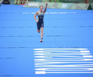 epa09368492 Gold medal winner Bermuda's Flora Duffy celebrates as she cross the finish line at the women's individual triathlon competition at the 2020 Tokyo Summer Olympics in Tokyo, Japan, 27 July 2021.  EPA/LAURENT GILLIERON