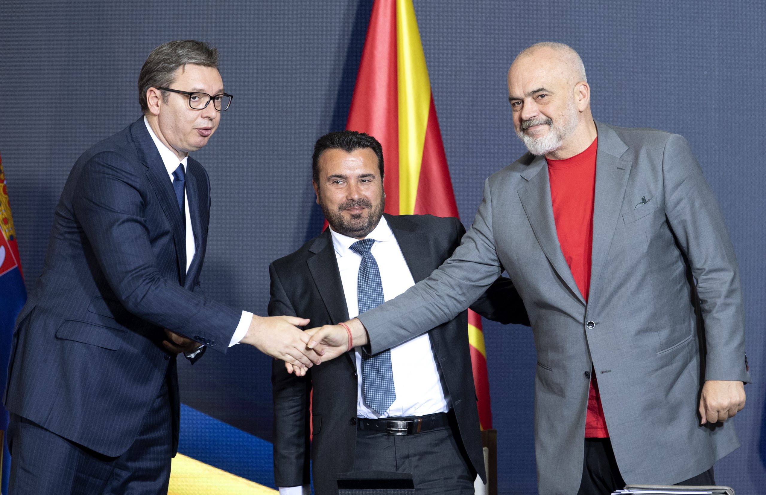 epa09376566 Serbian President Aleksandar Vucic (L), North Macedonia's Prime Minister Zoran Zaev (C) and Albanian Prime Minister Edi Rama (R) shake hands after signing documents during the Skopje Economic Forum on Regional Cooperation in Skopje, North Macedonia, 29 July 2021. The economic forum -- attended by Serbian President Vucic, Albanian Prime Minister Rama and North Macedonia's Prime Minister Zaev, who will present the political and economic vision of the integrated region --  is organized within the framework of the Four Freedoms Initiative, launched by the leaders of Albania, North Macedonia, and Serbia in October 2019.  EPA/GEORGI LICOVSKI