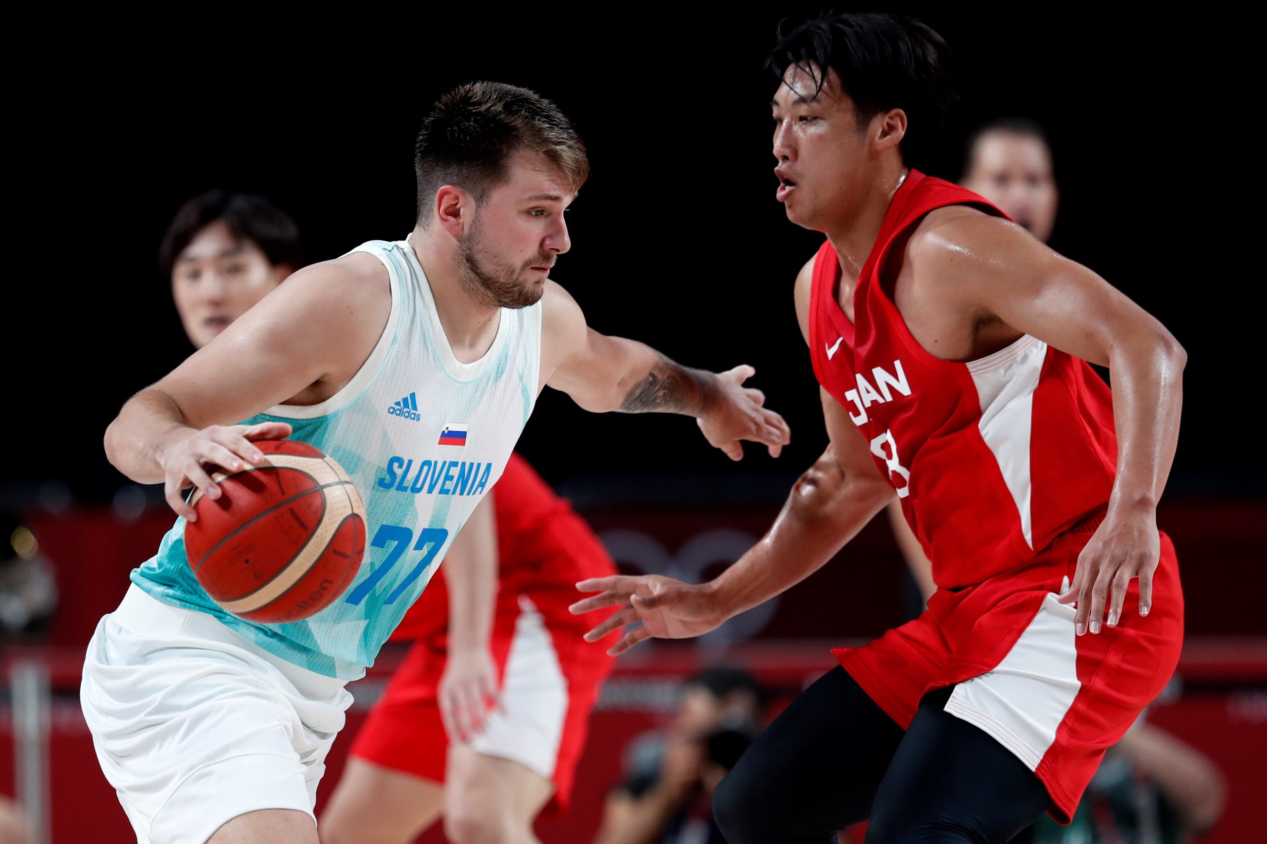 epa09375943 Luka Doncic (L) of Slovenia in action against Yudai Baba (R) of Japan in the men's preliminary round Group C match between Slovenia and Japan during the Basketball events of the Tokyo 2020 Olympic Games at the Saitama Super Arena in Saitama, Japan, 29 July 2021.  EPA/KIYOSHI OTA