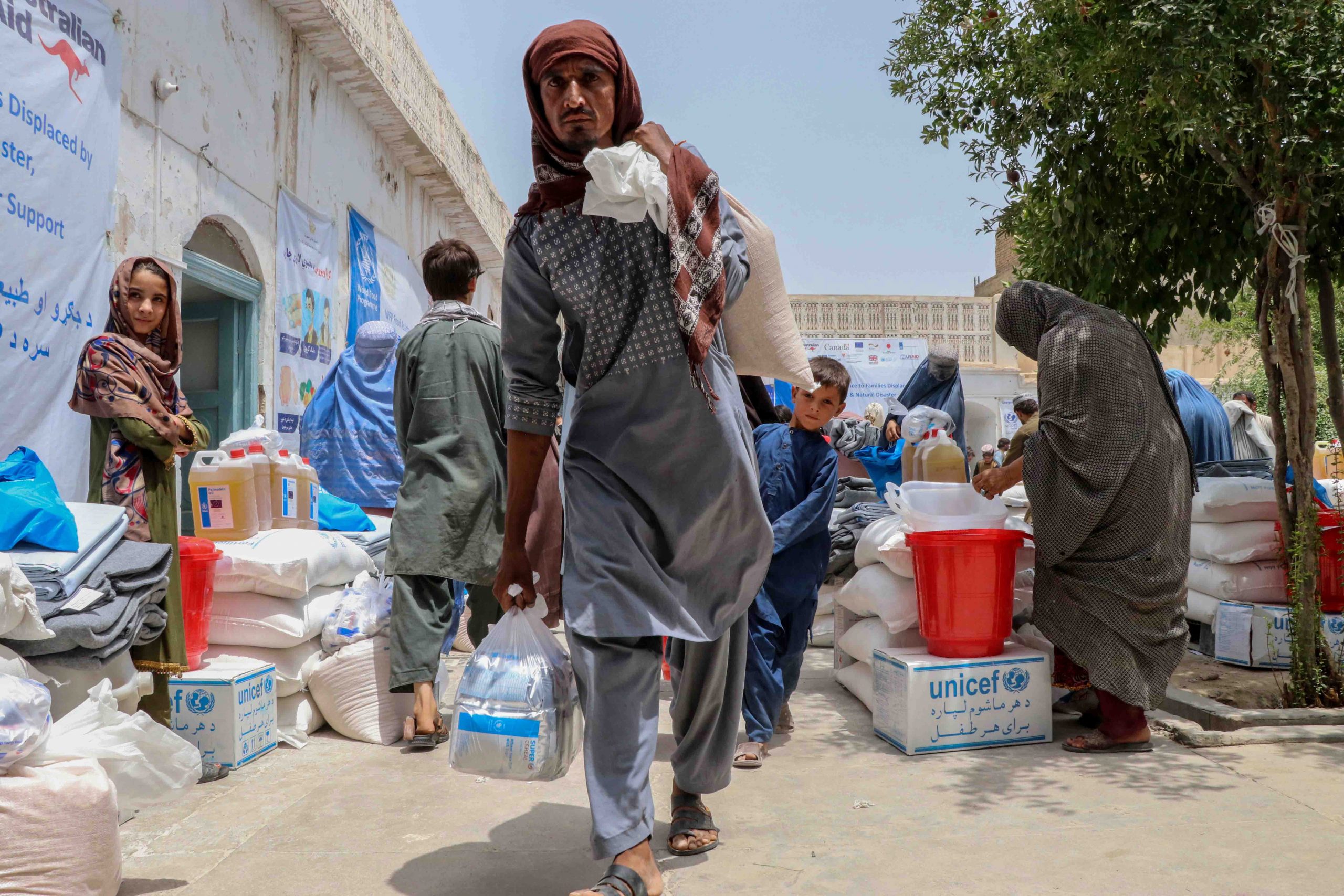 epa09380493 Afghans attend a ceremony organized by the United States Agency for International Development (USAID) to distribute relief supplies to families displaced from districts where fighting is ongoing between Afghan security forces and the Taliban, in Kandahar, Afghanistan, 30 July 2021. Civilian casualties in the armed conflict in Afghanistan increased by 47 percent in first six months of 2021 compared to the same period last year, according to the latest report by United Nations on 26 July 2021. This spike is mainly due to an increase in Taliban offensives in the wake of the withdrawal of the United States and NATO forces from Afghanistan starting 01 May.  EPA/M. SADIQ